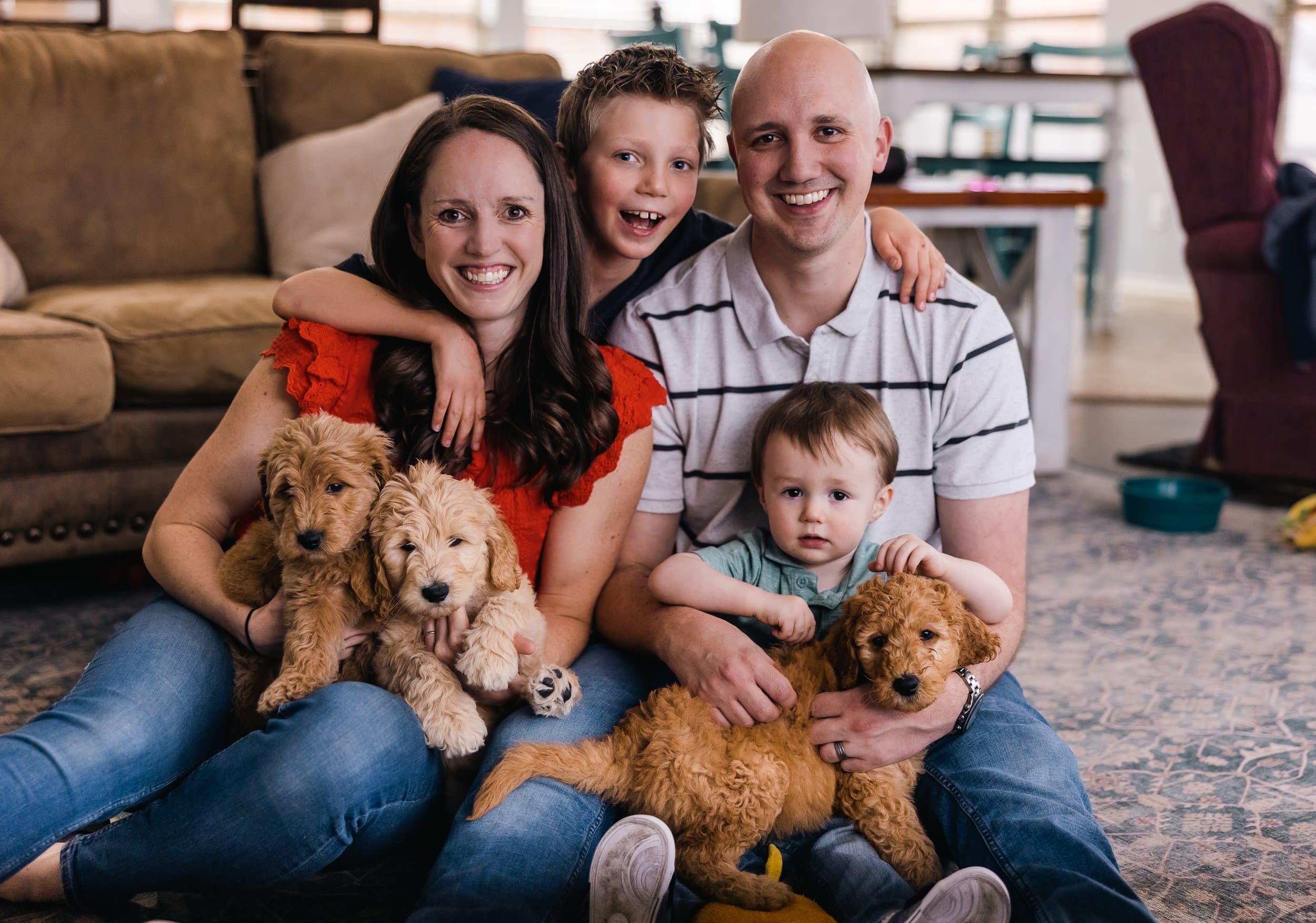 A happy Texas family holding their Purkey Puppies Goldendoodle puppies